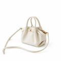 Cream handbag on white background